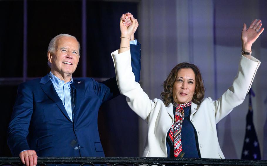 President Joe Biden and Vice President Kamala Harris raise their arms as guests cheer after watching the Independence Day fireworks from the White House in Washington, D.C., on July 4, 2024. 