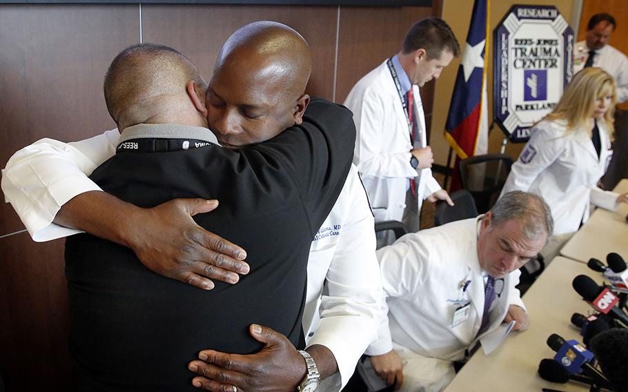 Dr. Brian Williams, staff surgeon in the Rees-Jones Trauma Center, embraces the trauma center’s medical director Dr. Alexander Eastman after speaking at a briefing at Parkland Hospital on July 11, 2016. 