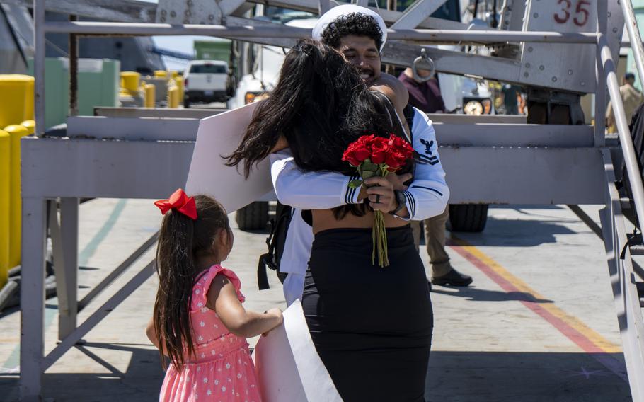 Mineman 2nd Class Humberto Nieves greets loved ones