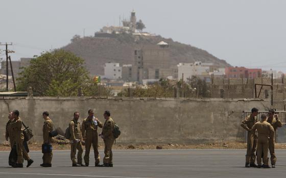 FILE - Members of a French military flight crew talk on the tarmac at France's military air base in Dakar, Senegal, between flights toward the presumed site of the crash of a missing Air France flight Tuesday, June 2, 2009. (AP Photo/Rebecca Blackwell, File)