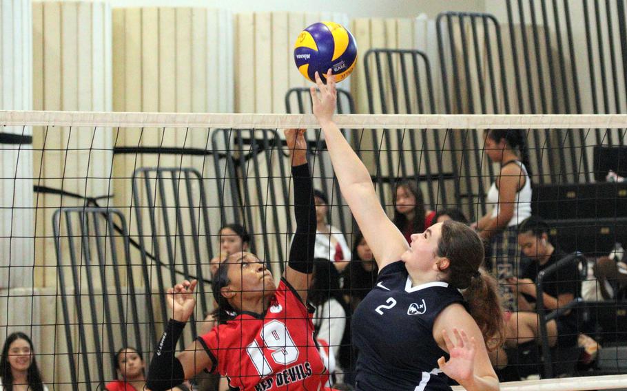 Nile C. Kinnick’s Alyssa Staples, left, had nine digs during Saturday’s Red Deivls four-set victory over Sacred Heart in a Kanto Plain match.