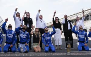 Kyle Larson, fourth from bottom left, celebrates with his crew after winning a NASCAR Cup Series auto race at Indianapolis Motor Speedway, Sunday, July 21, 2024, in Indianapolis. (AP Photo/Darron Cummings)