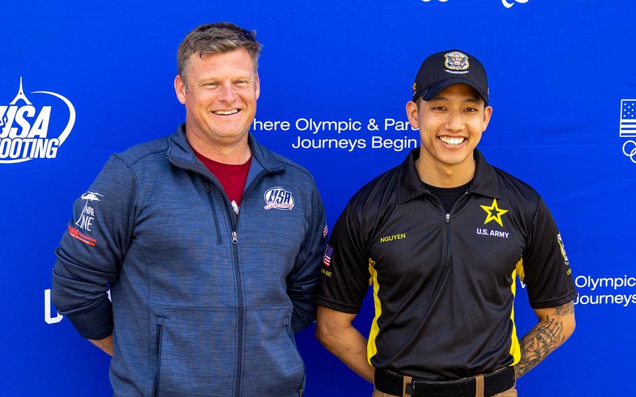 Army Staff Sgt. Kevin Nguyen, right, poses with his teammate, Sgt. 1st Class John Joss, during USA Shooting's Paralympic Trials - Part 3 in Talladega, Ala., in April 2024. Both soldiers have made Team USA and will compete in the 2024 Paris Paralympics this summer.