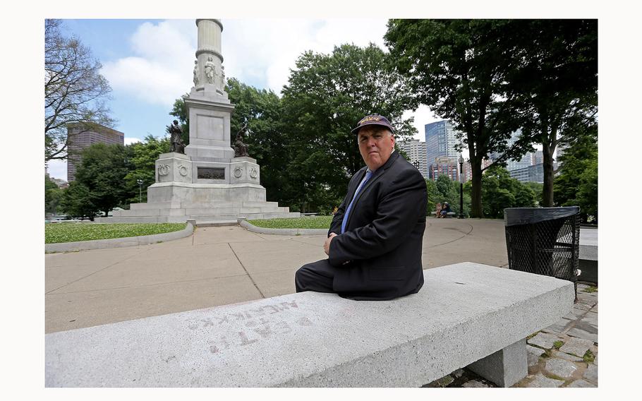 City Councilor Ed Flynn looks over the monument in Boston Common that was defaced on July 3, 2024, in Boston. “Death to Amerikkka” are the words etched into the bench on which Flynn is sitting.