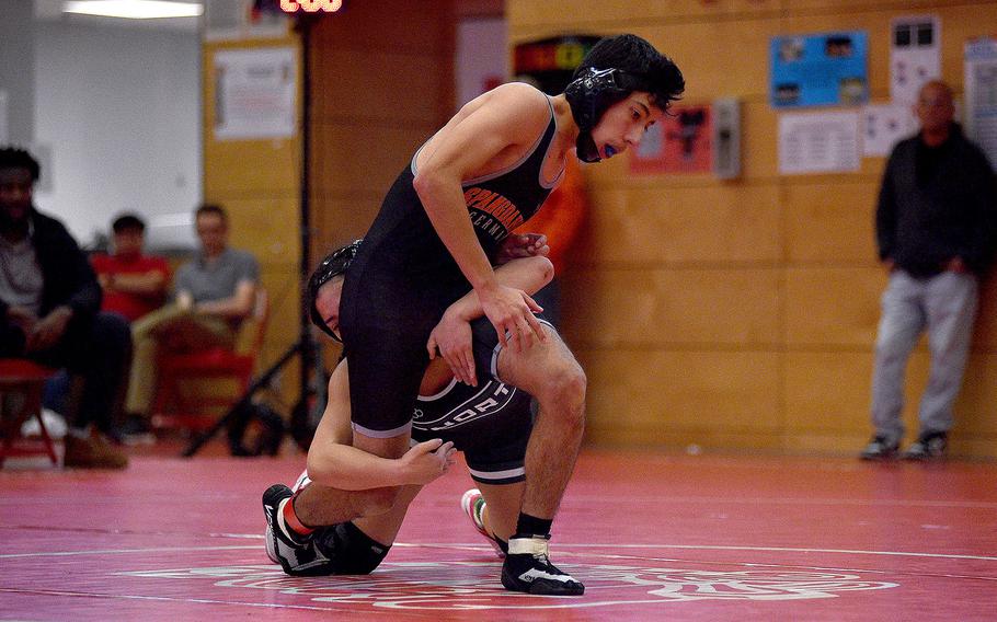 Spangdahlem's Caleb Truscott attempts to break the hold of AFNORTH's Richele Reyes during a 120-pound match at a wrestling meet on Dec. 9, 2023, at Kaiserslautern High School in Kaiserslautern, Germany.