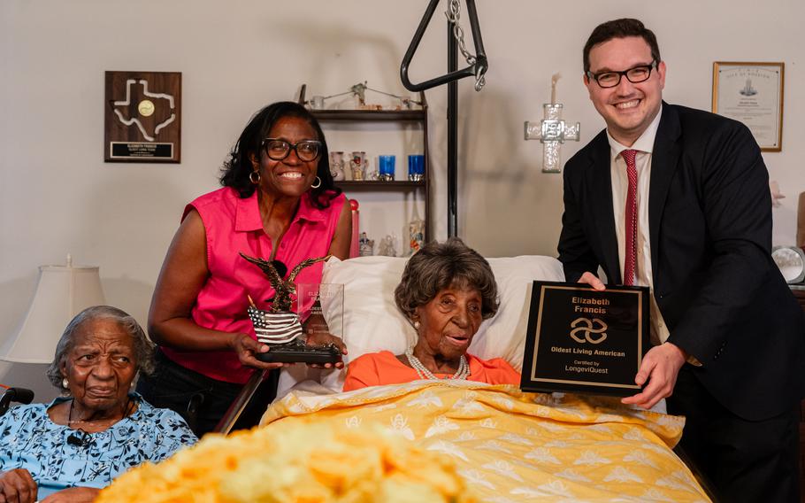 In April, Ben Meyers, right, presented Elizabeth Francis with a plaque to celebrate her status as the oldest person in the U.S. Francis is shown with her daughter, Dorothy Williams, left, and granddaughter Ethel Harrison. 