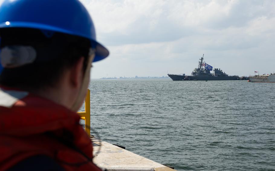 Seaman Richard Allmon looks on as the USS Laboon transits toward pier 5 