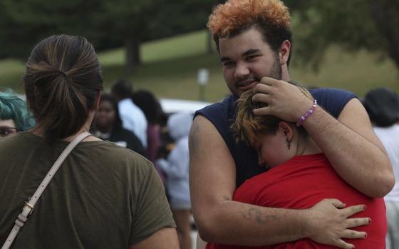 Artemis Else, right, hugs Angie Caswell as they wait outside Northwest high school after a shooting was reported Tuesday, Sept. 10, 2024, in Omaha, Neb.  (Megan Nielsen/Omaha World-Herald via AP)