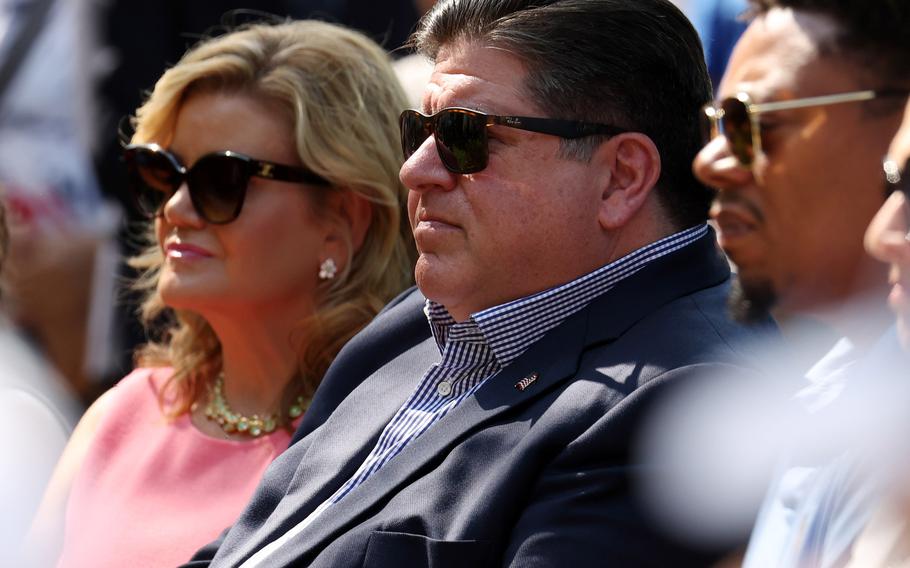 Illinois Gov. J.B. Pritzker and his wife, M.K. Pritzker, listen to speakers during a remembrance ceremony honoring the victims and survivors of the Highland Park shooting on July 4, 2023, in Highland Park, Ill. On Tuesday, April 30, 2024, the Pritzkers donated a historic document to the Abraham Lincoln Presidential Library and Museum in Springfield.