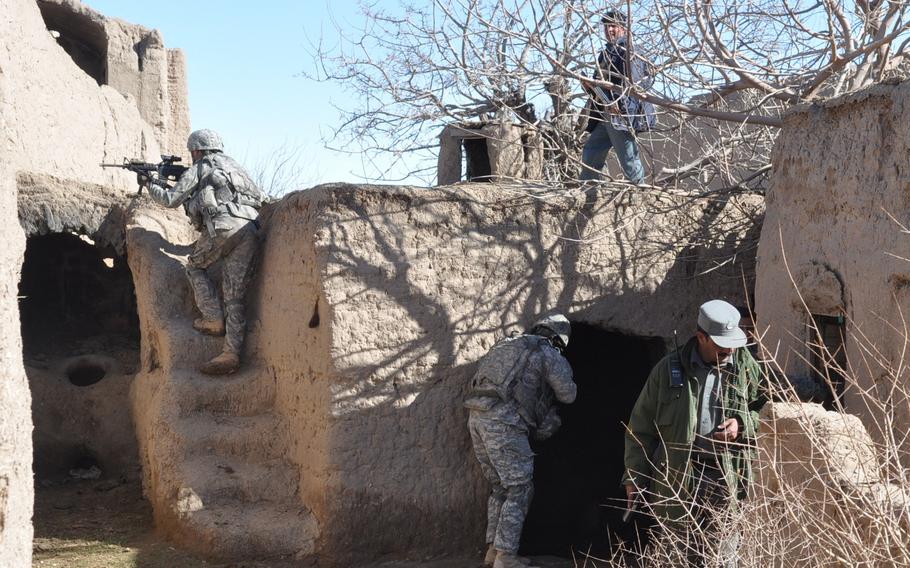 U.S. soldiers with the 4th Squadron, 73rd Cavalry Regiment of the 82nd Airborne and Afghan National Police search a suspect’s home in the village of Dashta Bam in the Pashtun Zarghun district of Herat province on Feb. 9 in search of a bomb triggerman. A small homemade bomb only partially exploded just after their vehicle passed earlier in the day, causing no damage.