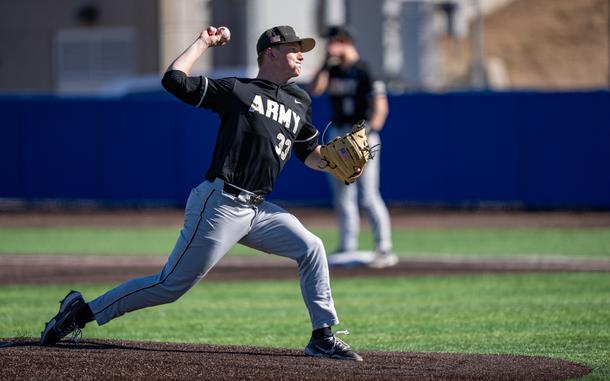 A pitcher leans into his throw just before the baseball is released.