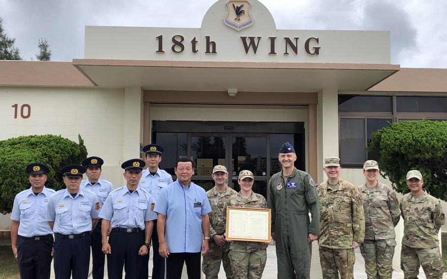 1st Lt. Regina Bean, center, of the 18th Operational Medical Readiness Squadron, receives a certificate of appreciation at Kadena Air Base, Okinawa, Jun. 6, 2024. Bean was honored for saving a motorcyclist's life in February.