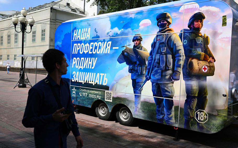 A man walks past a contract army service mobile recruitment point in Moscow.