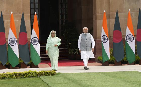 Indian Prime Minister Narendra Modi, right, with his Bangladeshi counterpart Sheikh Hasina walk for a photo call for media before their delegation level meeting, in New Delhi, India, Saturday, June 22, 2024. Hasina is on a two day state visit to India.(AP Photo/Manish Swarup)