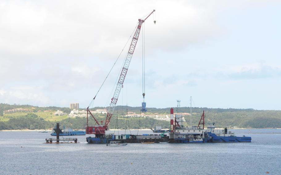 A crane used to drive test piles floats in Oura Bay at the site of a future U.S. Marine Corps runway at Camp Schwab, Okinawa, Japan, July 9, 2024.