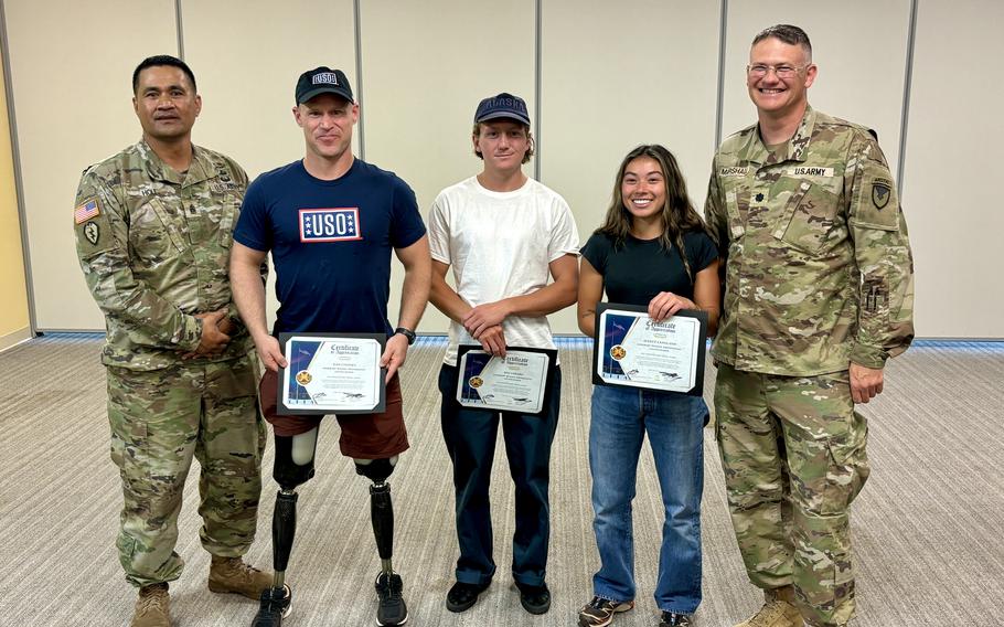 Olympians pose for a photo at Fort Greely, Alaska, during their USO-organized tour of Alaska military installations. 