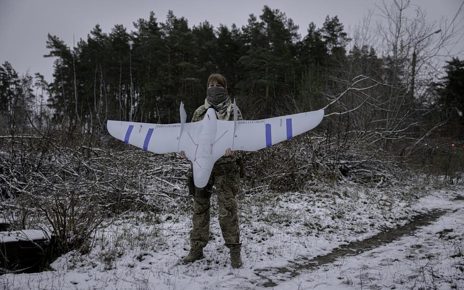 A Ukraine soldier holds a drone.