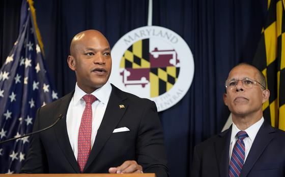 Maryland Gov. Wes Moore, left, flanked by Attorney General Anthony Brown, speaks during a news conference announcing a lawsuit seeking damages from the owners and managers of the Dali cargo ship that crashed into the Francis Key Scott Bridge, Tuesday, Sept. 24, 2024, in Baltimore. (AP Photo/Stephanie Scarbrough)