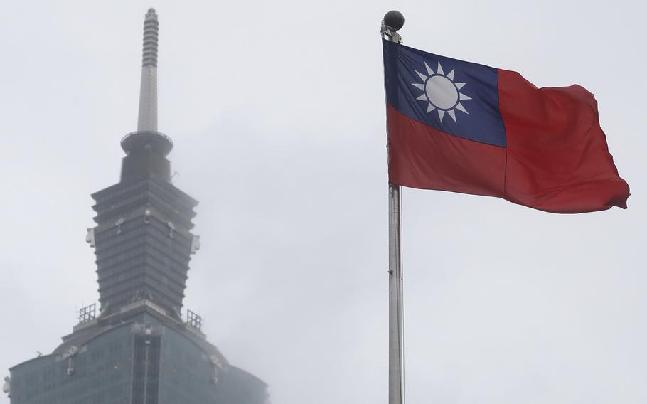 A Taiwan national flag flutters near the Taipei 101 building at the National Dr. Sun Yat-Sen Memorial Hall in Taipei, Taiwan.