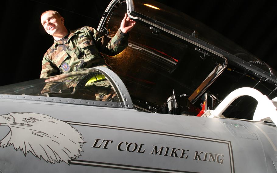 Senior Airman Cory Smith puts the final touches on an F-15 C