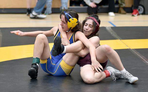 Baumholder's Leilanni Slye pulls Wiesbaden's Carmen Lima onto her back during a 110-pound pool-play match at the 2025 DODEA European wrestling championships on Feb. 6, 2025, at the Wiesbaden Sports and Fitness Center on Clay Kaserne in Wiesbaden, Germany.