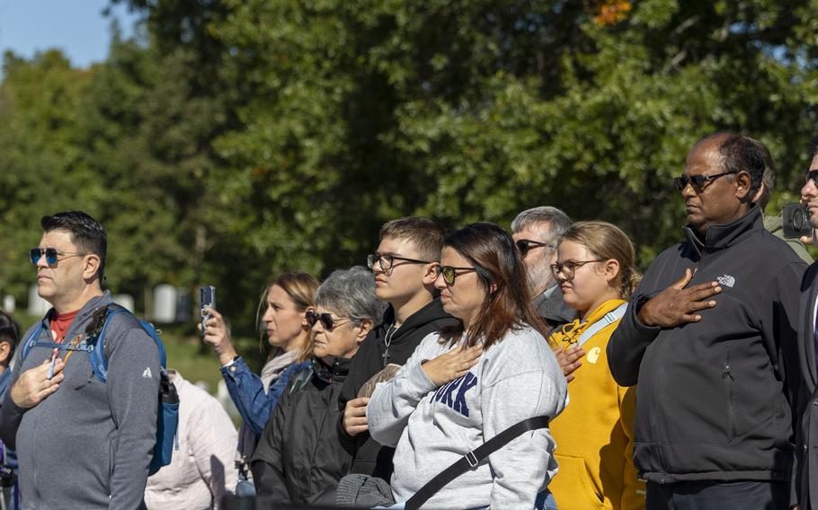 Attendees put their hands over their hearts as the National Anthem is played by the U.S. Army Band at Arlington National Cemetery in Arlington, Va., on Oct. 17, 2024.