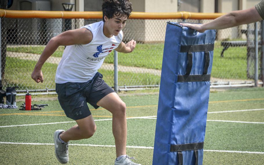 Luke Young, a ninth grade student of Osan Middle High School, performs a drill during football practice at Osan Air Base, South Korea, Monday, Aug. 5, 2024.