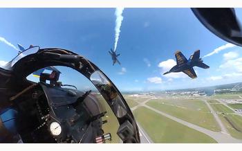 A video screen grab shows aircraft with a Navy Blue Angels team doing loops.