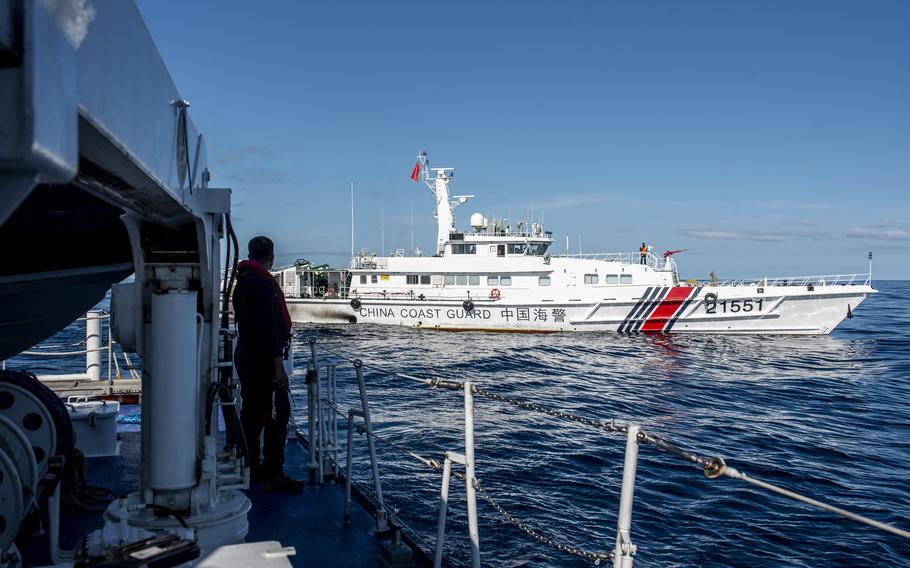 A Chinese coast guard ship is seen from the deck of a Philippine coast guard ship, Nov. 10, 2023.