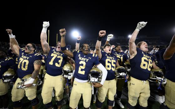 Navy celebrates their win over Charlotte by singing their alma mater "Navy Blue and Gold" after an NCAA college football game, Saturday, Oct. 19, 2024, in Annapolis, Md. (AP Photo/Nick Wass)