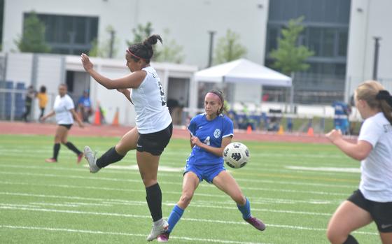 Stuttgart's Ayana Gomez blocks a shot from Ramstein's Isabel Fisher on Thursday, May 23, 2024, at the DODEA European Division I girls soccer championships at Ramstein Air Base, Germany.