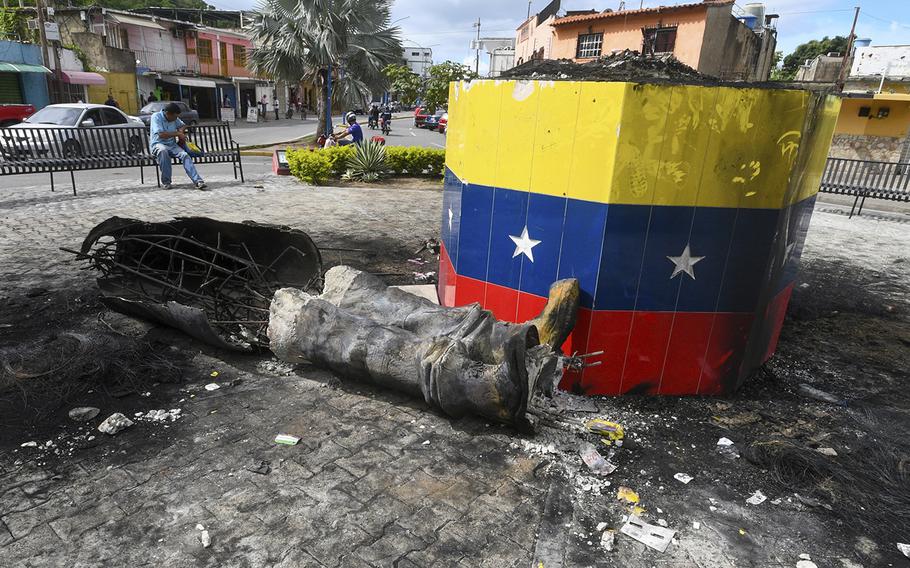 A destroyed statue of the late Venezuelan President Hugo Chavez lays next to its base in Valencia, Venezuela, on July 31, 2024.