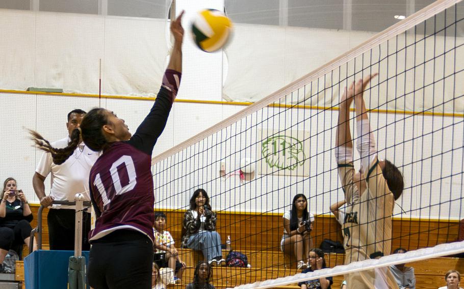 Zama‘s Emma Sakamoto-Flack spikes against Robert D. Edgren’s Kaiya Paison during Friday’s DODEA-Japan volleyball match. The Trojans won in straight sets.