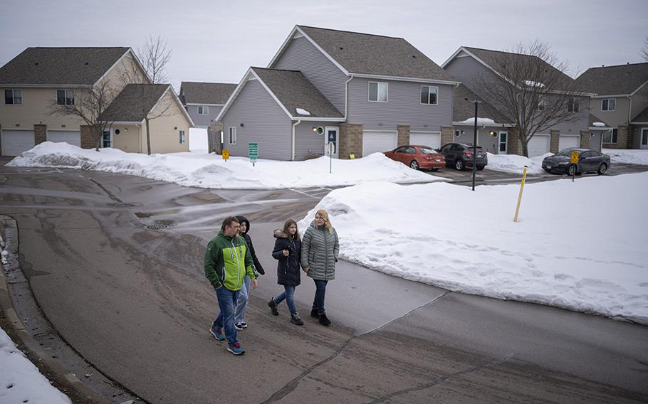 Artem, Polina, Dasha, and Katya, from left, take a walk after dinner in their Shakopee neighborhood on March 15, 2023. 