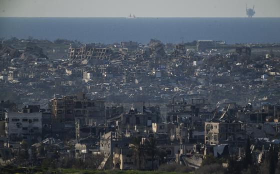 Buildings destroyed during the Israeli air and ground offensive stand in the Gaza Strip are seen from southern Israel, Sunday, March 2, 2025. (AP Photo/Leo Correa)