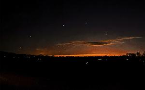 This photo provided by Trisha Bushey shows the evening sky and points of light near in Lebanon Township, N.J., on Thursday, Dec. 5, 2024. (Trisha Bushey via AP)