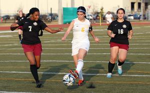 Yokota's Jessica Franks works her way between Perry's Kelci Ferrell-Martin and Hailey Navarro.