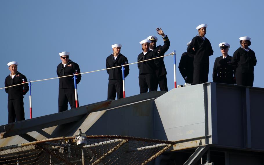 Sailors man the rails of the aircraft carrier USS George Washington as it steams toward its old homeport, Yokosuka Naval Base, Japan, Nov. 22, 2024.