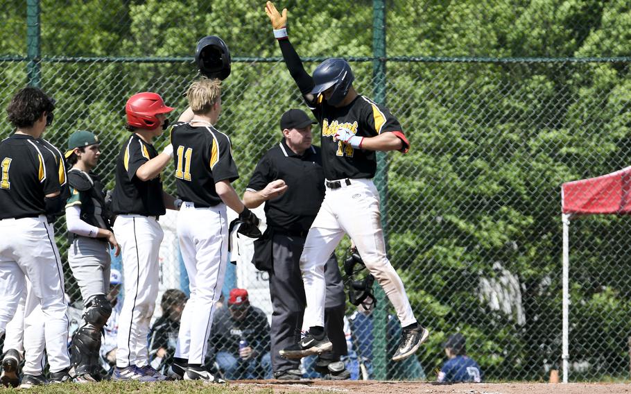 Stuttgart pitcher Hayden Foley jumps into the air after hitting a home run in a 22-8 victory over SHAPE during a 2024 DODEA European baseball championship game against Spangdahlem on May 22, 2024, at Southside Fitness Center on Ramstein Air Base, Germany.