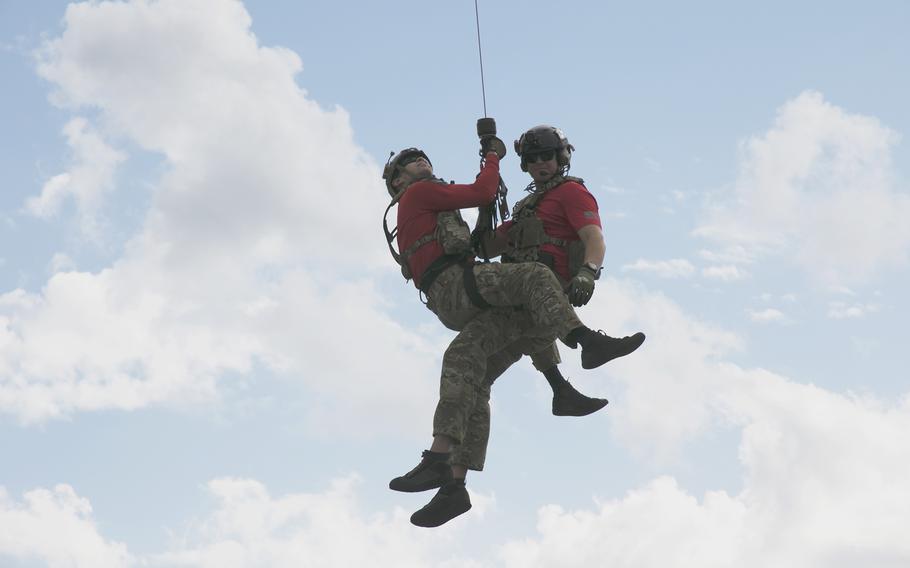 Air Force pararescue specialists of 33rd Rescue Squadron are lowered to the deck of the USAV Fort McHenry on Nov. 10, 2021.