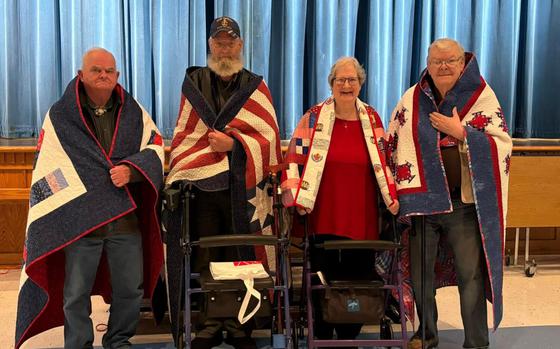 The North Central Quilts of Valor group presented quilts on Nov. 8, to four area veterans at Tonasket High School. They are from left, Richard J. (U.S. Marines), 1965-1969, Ronald L. (U.S. Navy), 1971-1992, Linda F. (U.S. Air Force), 1971-1973, and James M. (U.S. Navy), 1959-1965.