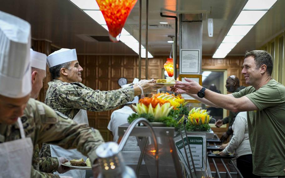 Troops receive food during a Thanksgiving celebration at Naval Station Guantanamo Bay.