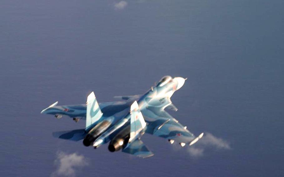  A Russian Su-27 Flanker fighter jet flies in a clear sky.