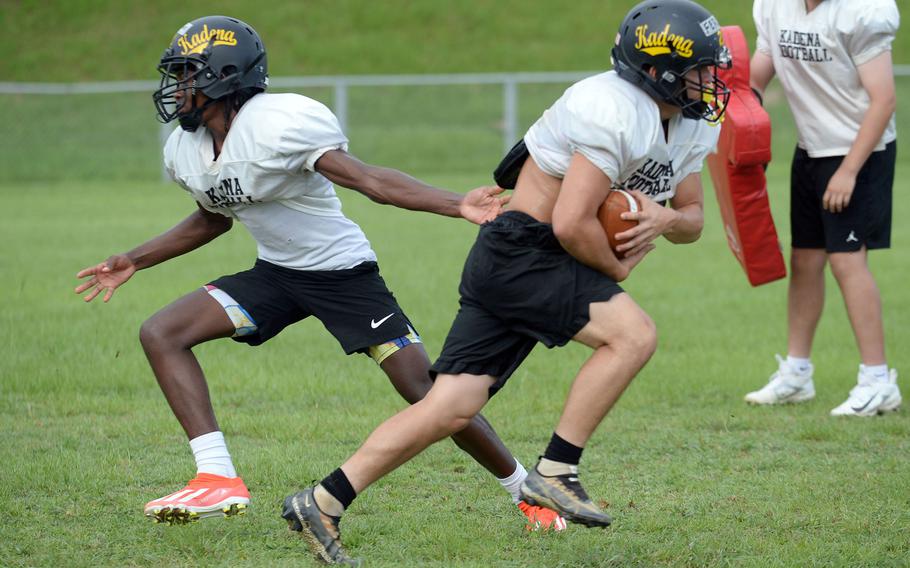 Quarterback DeShaun Nixon hands off to running back Ethan Ferch in practice and that could happen quite a bit in Kadena’s backfield this season.