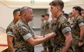 Marine Corps Cpl. Austin Potter is awarded the Navy and Marine Corps Achievement Medal at Camp Schwab, Okinawa, Oct. 10, 2024. 