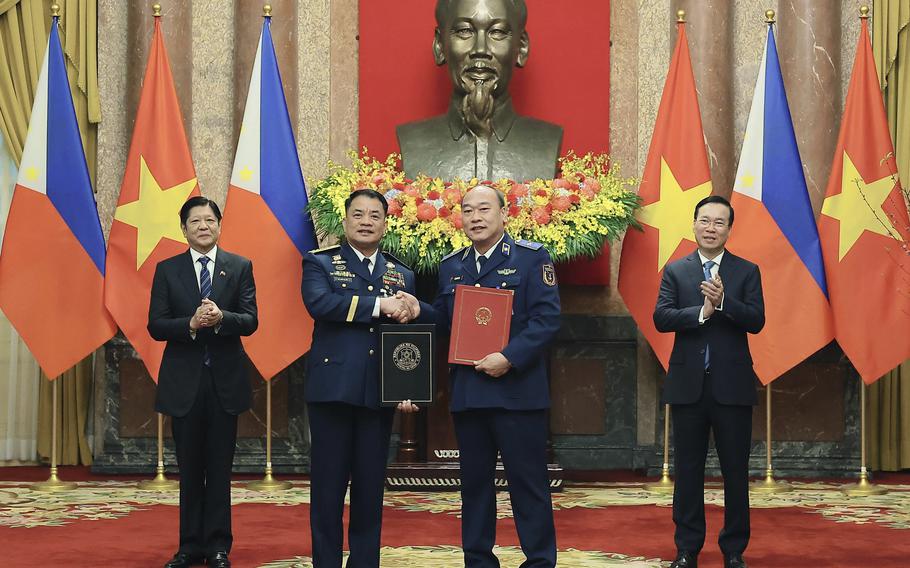 Philippine President Ferdinand Marcos Jr., left, and Vietnamese President Vo Van Thuong, right, look on as the Philippine Coastguard Commander Adm. Ronnie Gil Gavan and Vietnamese Coastguard Commander Le Quang Dao exchange signed documents in Hanoi, Vietnam Tuesday, Jan. 30, 2024. Vietnam is ready to hold talks with the Philippines to settle their overlapping claims to the undersea continental shelf in the South China Sea, official Vietnamese media said Friday, June 21, 2024, in a diplomatic approach that contrasts with China’s increasingly assertive actions to fortify its claims in the contested waters. 