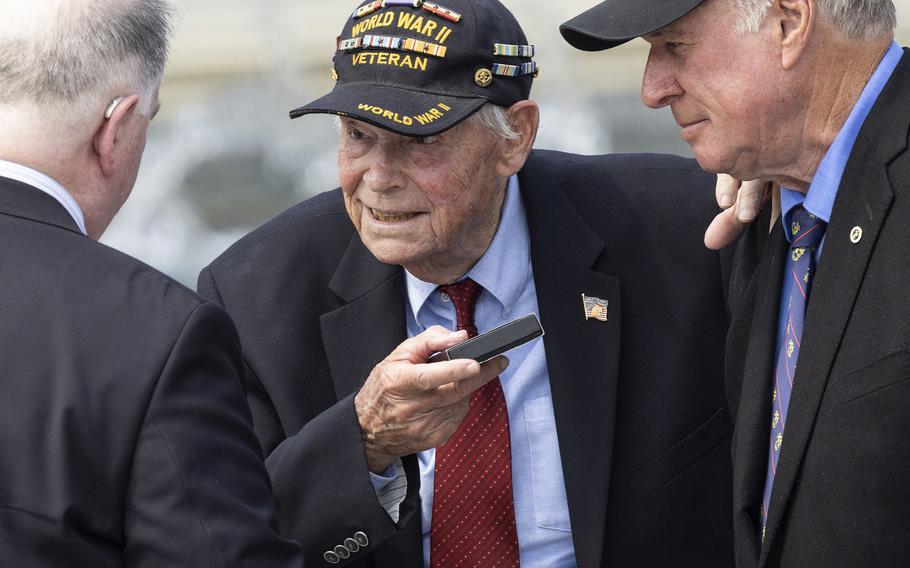 Veteran Les Jones receives a Greatest Generation coin from U.S. Miny Chief Counsel John Schorn at the 20th anniversary celebration of the National World War II Memorial in Washington, May 25, 2024.