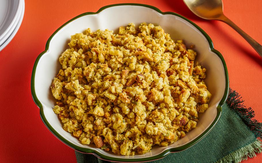 A bowl of prepared Stove Top Chicken Stuffing Mix next to a spoon. 