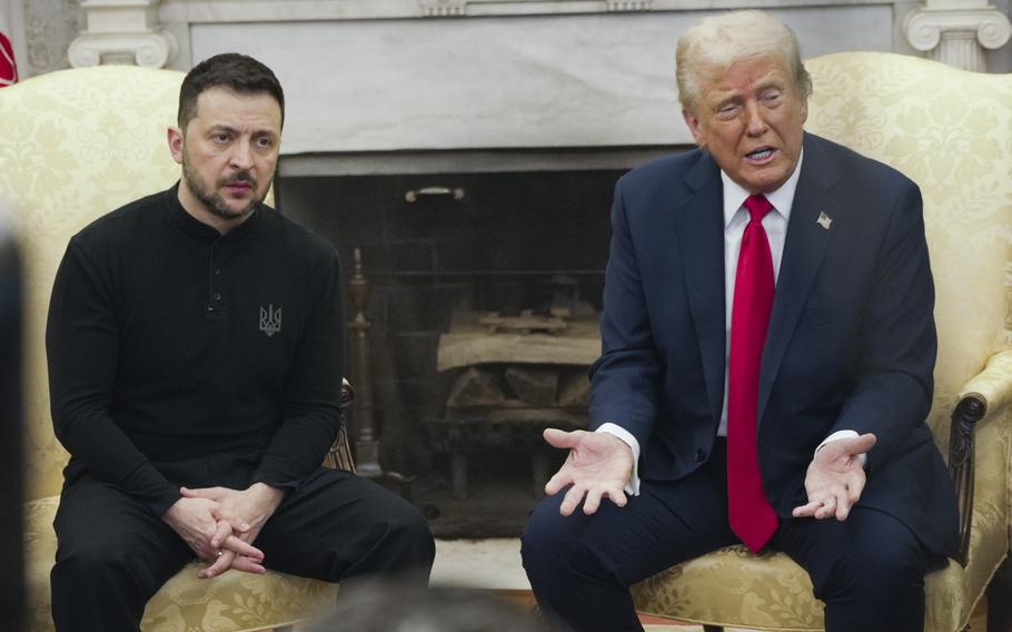 Donald Trump and Volodymyr Zelenskyy sit beside each other in yellow chairs in front of a fireplace in the Oval Office of the White House.