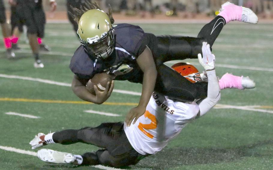 Humphreys' Joshua Canion gets brought down by Nile C. Kinnick's Xavier Wright.